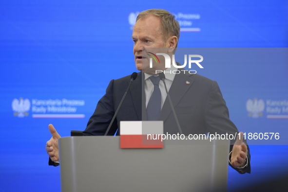 Polish Prime Minister Donald Tusk gestures as he speaks during a press conference with French President Emmanuel Macron after talks in Warsa...