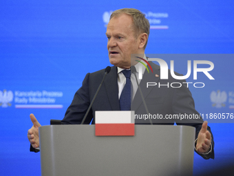 Polish Prime Minister Donald Tusk gestures as he speaks during a press conference with French President Emmanuel Macron after talks in Warsa...