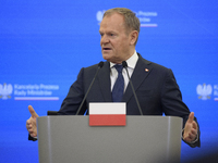 Polish Prime Minister Donald Tusk gestures as he speaks during a press conference with French President Emmanuel Macron after talks in Warsa...