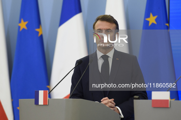 French President Emmanuel Macron looks on during a press conference with Polish Prime Minister Donald Tusk after talks in Warsaw, Poland, on...