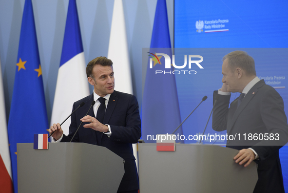 French President Emmanuel Macron and Polish Prime Minister Donald Tusk hold a press conference after talks in Warsaw, Poland, on December 12...