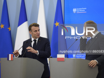 French President Emmanuel Macron and Polish Prime Minister Donald Tusk hold a press conference after talks in Warsaw, Poland, on December 12...