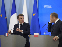 French President Emmanuel Macron and Polish Prime Minister Donald Tusk hold a press conference after talks in Warsaw, Poland, on December 12...