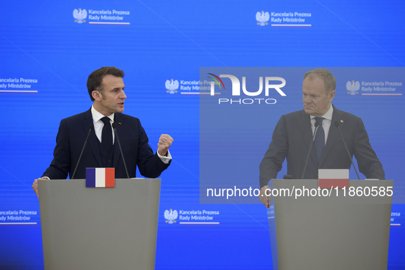 French President Emmanuel Macron gestures as he speaks during a press conference with Polish Prime Minister Donald Tusk after talks in Warsa...