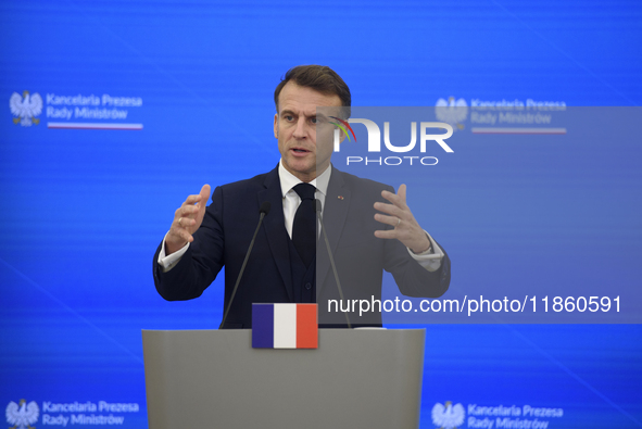 French President Emmanuel Macron gestures as he speaks during a press conference with Polish Prime Minister Donald Tusk after talks in Warsa...