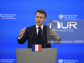 French President Emmanuel Macron gestures as he speaks during a press conference with Polish Prime Minister Donald Tusk after talks in Warsa...