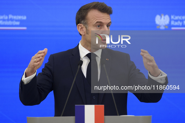 French President Emmanuel Macron gestures as he speaks during a press conference with Polish Prime Minister Donald Tusk after talks in Warsa...