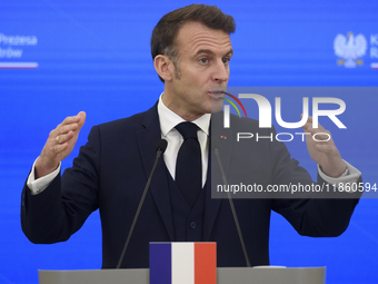 French President Emmanuel Macron gestures as he speaks during a press conference with Polish Prime Minister Donald Tusk after talks in Warsa...