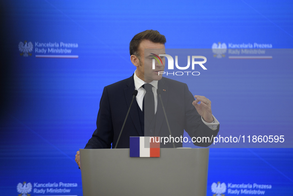 French President Emmanuel Macron gestures as he speaks during a press conference with Polish Prime Minister Donald Tusk after talks in Warsa...