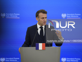 French President Emmanuel Macron gestures as he speaks during a press conference with Polish Prime Minister Donald Tusk after talks in Warsa...