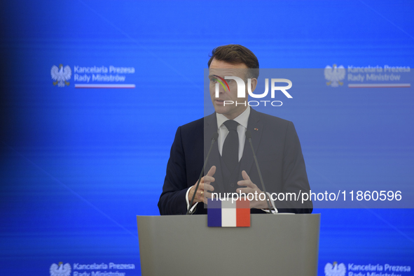 French President Emmanuel Macron gestures as he speaks during a press conference with Polish Prime Minister Donald Tusk after talks in Warsa...