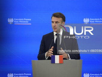 French President Emmanuel Macron gestures as he speaks during a press conference with Polish Prime Minister Donald Tusk after talks in Warsa...