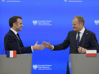 French President Emmanuel Macron and Polish Prime Minister Donald Tusk hold a press conference after talks in Warsaw, Poland, on December 12...