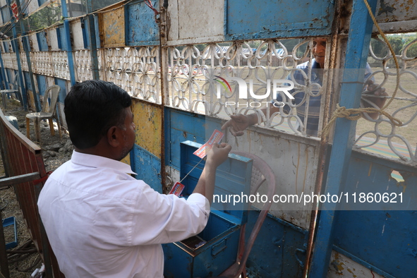 A man buys a ticket from a ticket counter at the Ajanta Circus entry gate in Kolkata, India, on December 12, 2024. There are currently fewer...