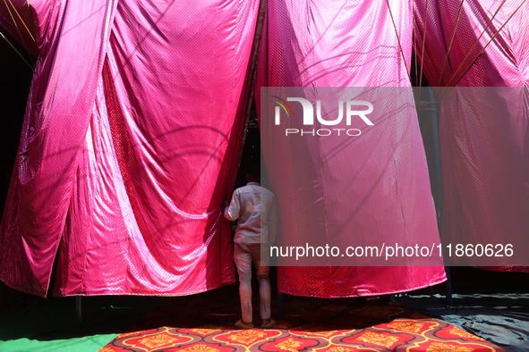 A circus artiste waits before a show of the Ajanta Circus in Kolkata, India, on December 12, 2024. There are currently fewer than 30 circuse...