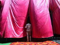 A circus artiste waits before a show of the Ajanta Circus in Kolkata, India, on December 12, 2024. There are currently fewer than 30 circuse...