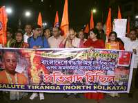 An activist of the Bengali Hindu Protection Association stands with a poster featuring a portrait of Bangladesh's interim leader Muhammad Yu...