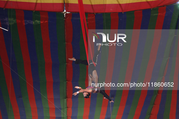 Trapeze artists perform during a show of the Ajanta Circus in Kolkata, India, on December 12, 2024. There are currently fewer than 30 circus...