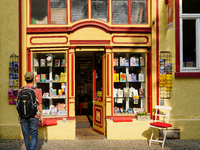 A young man stops to admire the display of books in the windows of Buchladen Die Zeitgenossen in Esslingen, Germany, on June 30, 2023. The b...