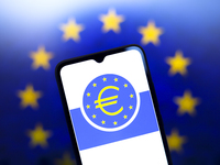 The European Central Bank (ECB) logo appears on the screen of a smartphone, and in the background, the flag of the European Union is visible...