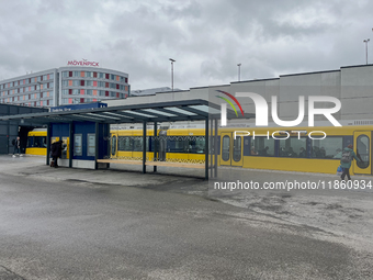 A yellow tram of the Stuttgart Stadtbahn serves passengers at Stuttgart Airport Messe Station in Stuttgart, Germany, on March 10, 2023. The...