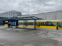 A yellow tram of the Stuttgart Stadtbahn serves passengers at Stuttgart Airport Messe Station in Stuttgart, Germany, on March 10, 2023. The...