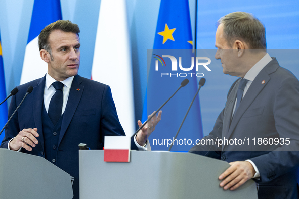 French President Emmanuel Macron (L)  and Prime Minister Donald Tusk make a statement after a meeting at the Prime Minister's Office in Wars...