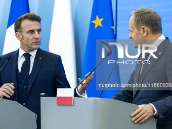 French President Emmanuel Macron (L)  and Prime Minister Donald Tusk make a statement after a meeting at the Prime Minister's Office in Wars...