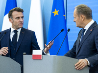 French President Emmanuel Macron (L)  and Prime Minister Donald Tusk make a statement after a meeting at the Prime Minister's Office in Wars...