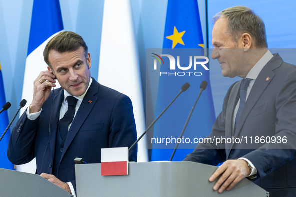 French President Emmanuel Macron (L)  and Prime Minister Donald Tusk make a statement after a meeting at the Prime Minister's Office in Wars...