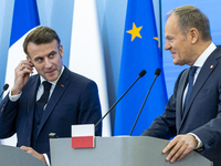 French President Emmanuel Macron (L)  and Prime Minister Donald Tusk make a statement after a meeting at the Prime Minister's Office in Wars...