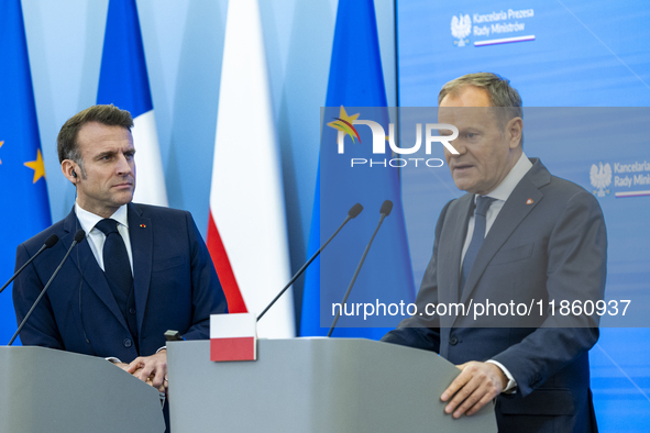 Prime Minister Donald Tusk and French President Emmanuel Macron make a statement after a meeting at the Prime Minister's Office in Warsaw. T...