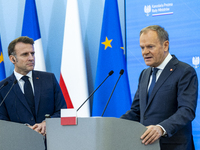 Prime Minister Donald Tusk and French President Emmanuel Macron make a statement after a meeting at the Prime Minister's Office in Warsaw. T...