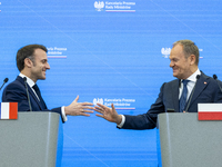 Prime Minister Donald Tusk and French President Emmanuel Macron make a statement after a meeting at the Prime Minister's Office in Warsaw. T...