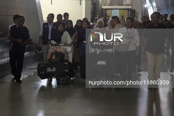 Indonesian citizens (WNI) walk out of the arrivals terminal shortly after arriving from Syria at Soekarno-Hatta Airport in Tangerang, Banten...