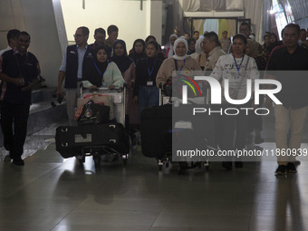 Indonesian citizens (WNI) walk out of the arrivals terminal shortly after arriving from Syria at Soekarno-Hatta Airport in Tangerang, Banten...