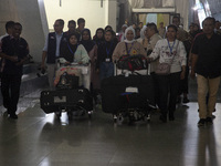 Indonesian citizens (WNI) walk out of the arrivals terminal shortly after arriving from Syria at Soekarno-Hatta Airport in Tangerang, Banten...