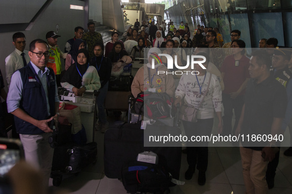 Indonesian citizens (WNI) walk out of the arrivals terminal shortly after arriving from Syria at Soekarno-Hatta Airport in Tangerang, Banten...