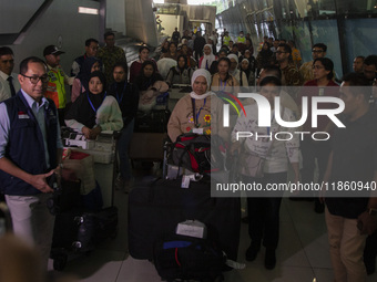 Indonesian citizens (WNI) walk out of the arrivals terminal shortly after arriving from Syria at Soekarno-Hatta Airport in Tangerang, Banten...