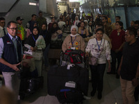 Indonesian citizens (WNI) walk out of the arrivals terminal shortly after arriving from Syria at Soekarno-Hatta Airport in Tangerang, Banten...