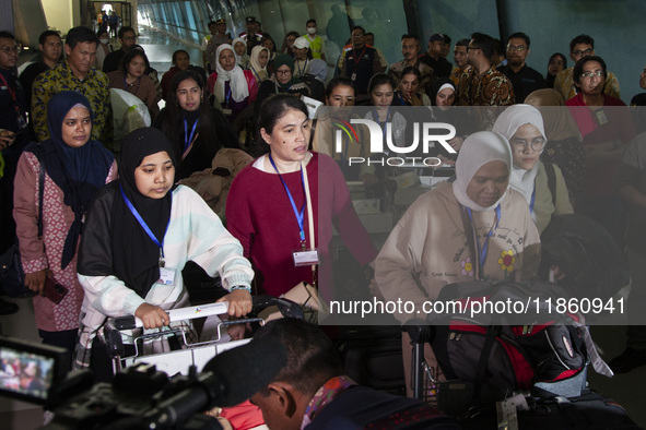 Indonesian citizens (WNI) walk out of the arrivals terminal shortly after arriving from Syria at Soekarno-Hatta Airport in Tangerang, Banten...