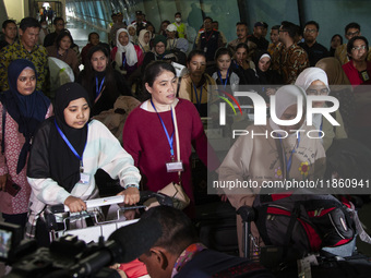 Indonesian citizens (WNI) walk out of the arrivals terminal shortly after arriving from Syria at Soekarno-Hatta Airport in Tangerang, Banten...