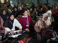 Indonesian citizens (WNI) walk out of the arrivals terminal shortly after arriving from Syria at Soekarno-Hatta Airport in Tangerang, Banten...