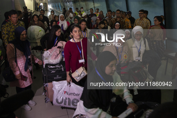 Indonesian citizens (WNI) walk out of the arrivals terminal shortly after arriving from Syria at Soekarno-Hatta Airport in Tangerang, Banten...