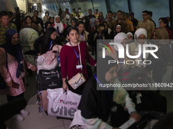 Indonesian citizens (WNI) walk out of the arrivals terminal shortly after arriving from Syria at Soekarno-Hatta Airport in Tangerang, Banten...