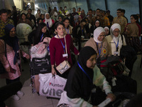 Indonesian citizens (WNI) walk out of the arrivals terminal shortly after arriving from Syria at Soekarno-Hatta Airport in Tangerang, Banten...