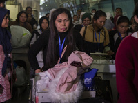 Indonesian citizens (WNI) walk out of the arrivals terminal shortly after arriving from Syria at Soekarno-Hatta Airport in Tangerang, Banten...