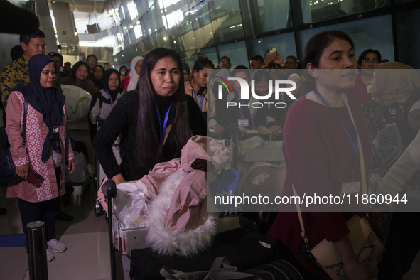 Indonesian citizens (WNI) walk out of the arrivals terminal shortly after arriving from Syria at Soekarno-Hatta Airport in Tangerang, Banten...