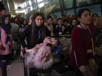 Indonesian citizens (WNI) walk out of the arrivals terminal shortly after arriving from Syria at Soekarno-Hatta Airport in Tangerang, Banten...