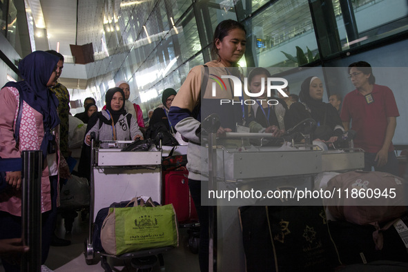 Indonesian citizens (WNI) walk out of the arrivals terminal shortly after arriving from Syria at Soekarno-Hatta Airport in Tangerang, Banten...